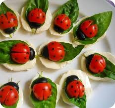 Healthy snack food ladybugs made by young children using cheese and tomatoes