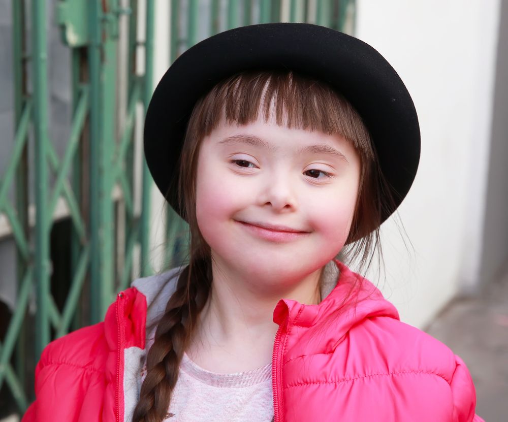 Smiling young girl with autism spectrum disorder