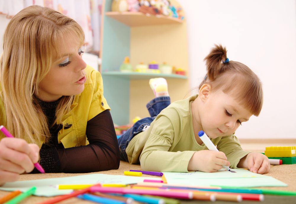 Teacher with toddler in classroom