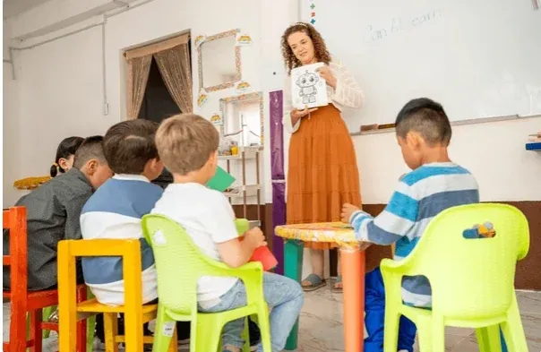 Children playing with educational toys in a bright classroom