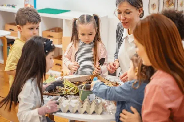 Children studying a plant in a preschool classroom